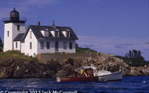 Lobster boat working in front of Indian Island Lighthouse