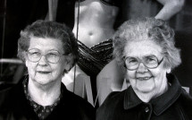 Two older women wait for bus