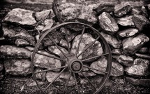 Wagon wheel against stone wall at R Farms, Lebanon, CT
